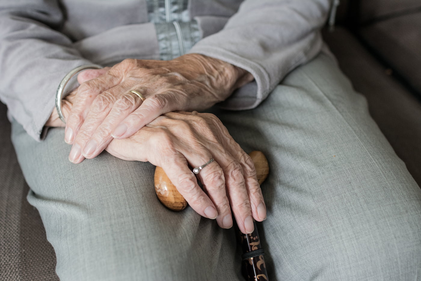 A grandmother's hands holding an old family photograph